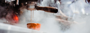 Serve Coffee steaming espresso dripping int a cup